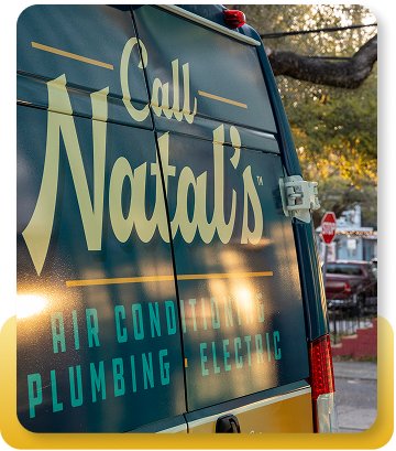 a work van with a mascot on the side in front of a neighborhood